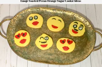 Decorated emoji sugar cookie ideas laid out on a platter.