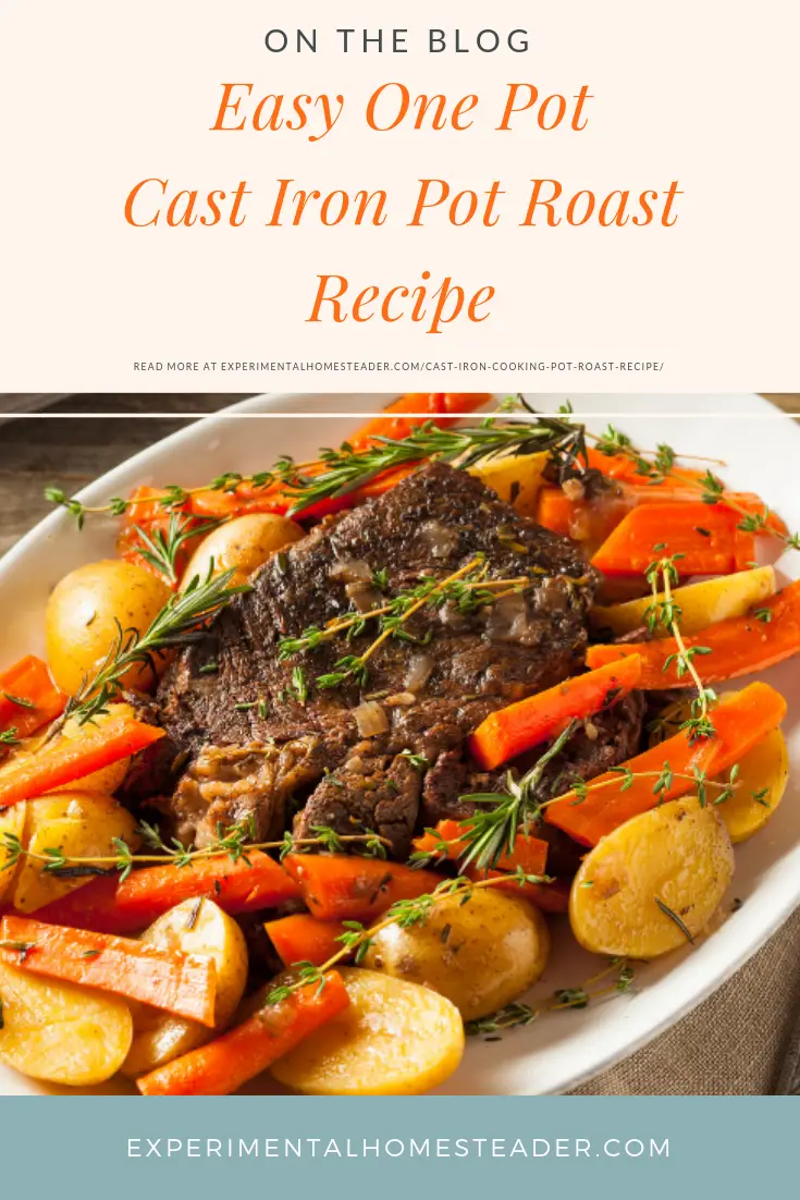 Pot roast with potatoes and carrots garnished with thyme and rosemary on a platter.