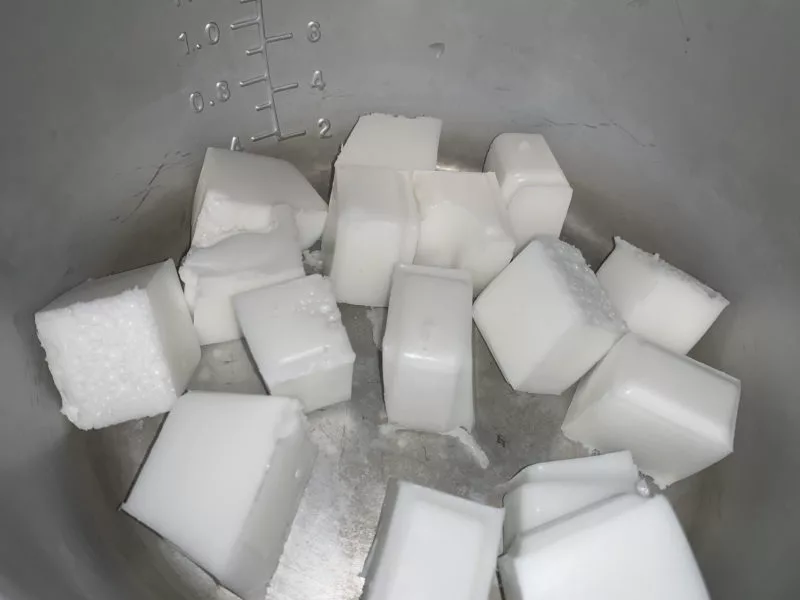 The soap cubes in a soap melting pot.