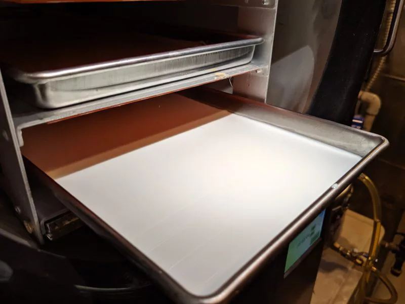 Milk in a freeze dryer tray.