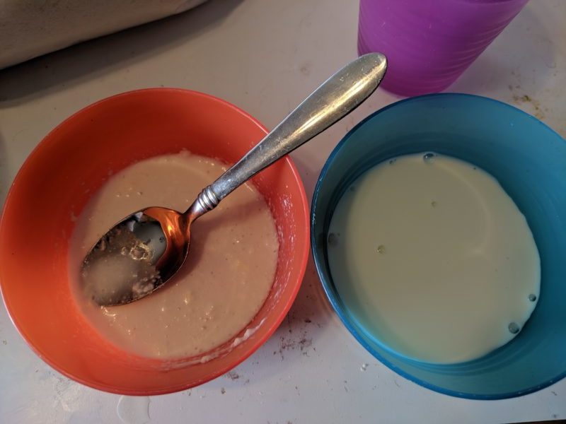 Freeze dried milk in the orange bowl and regular milk in the blue bowl.