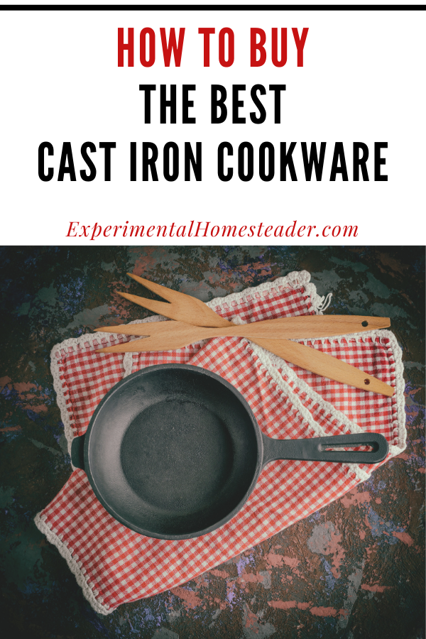 A cast iron skillet sitting on red and white checkered placemats with wooden cooking forks laying beside it.