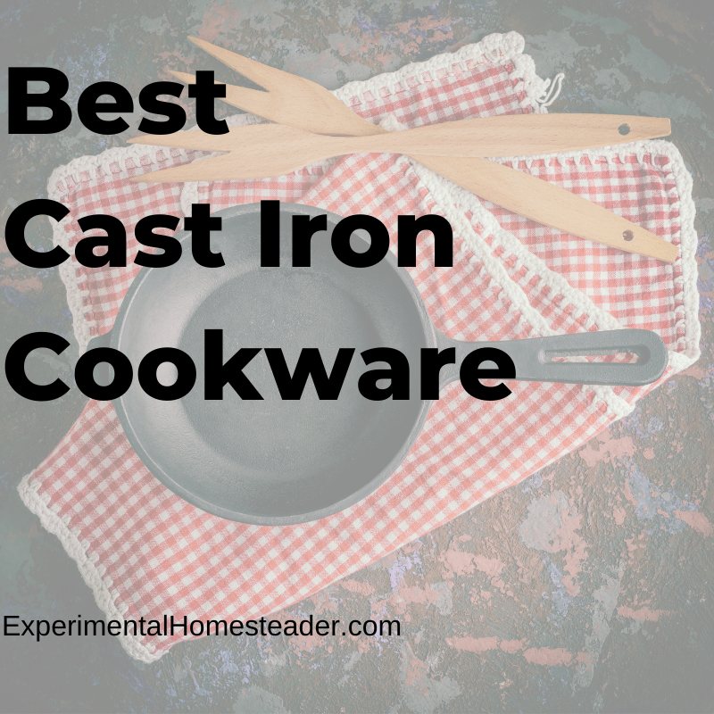 A cast iron skillet sitting on red and white checkered placemats with wooden cooking forks laying beside it.