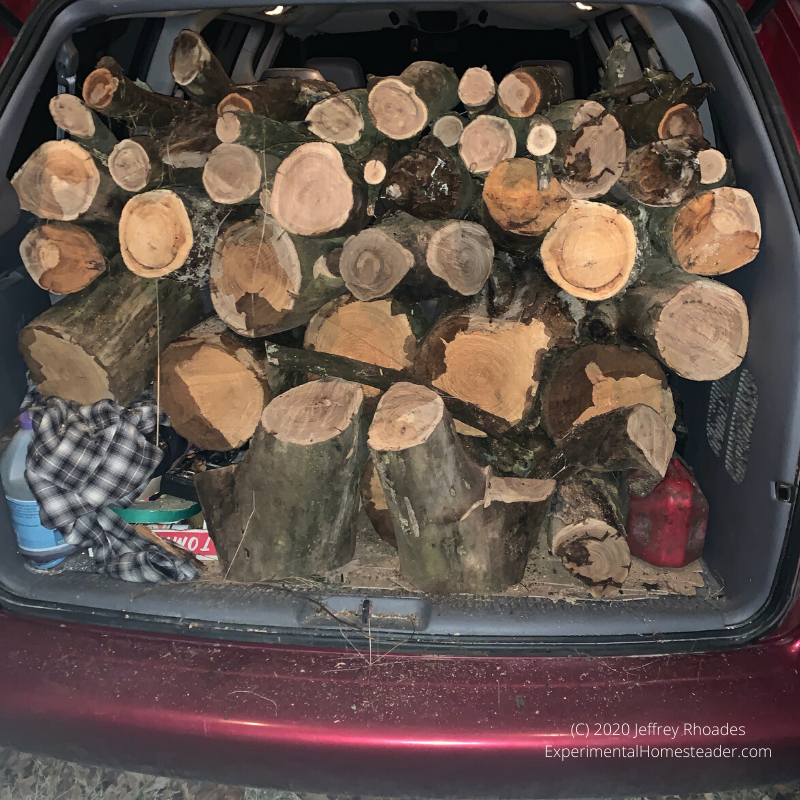 The back of the van filled with cut wood.