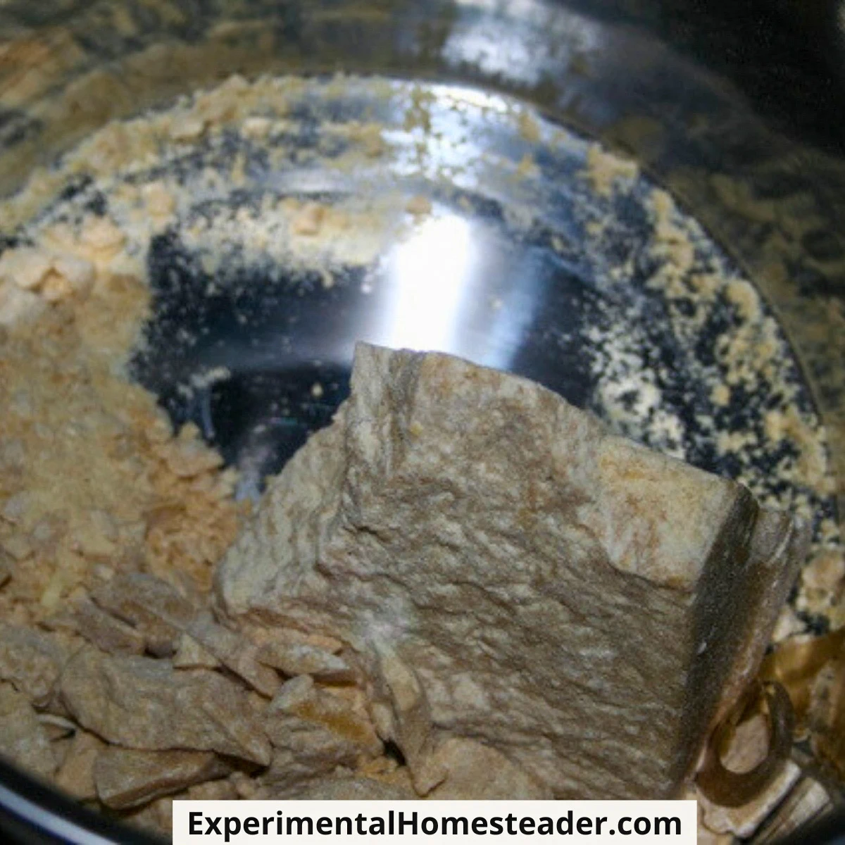 Solid chunks of cocoa butter placed in the top pan of a double boiler.